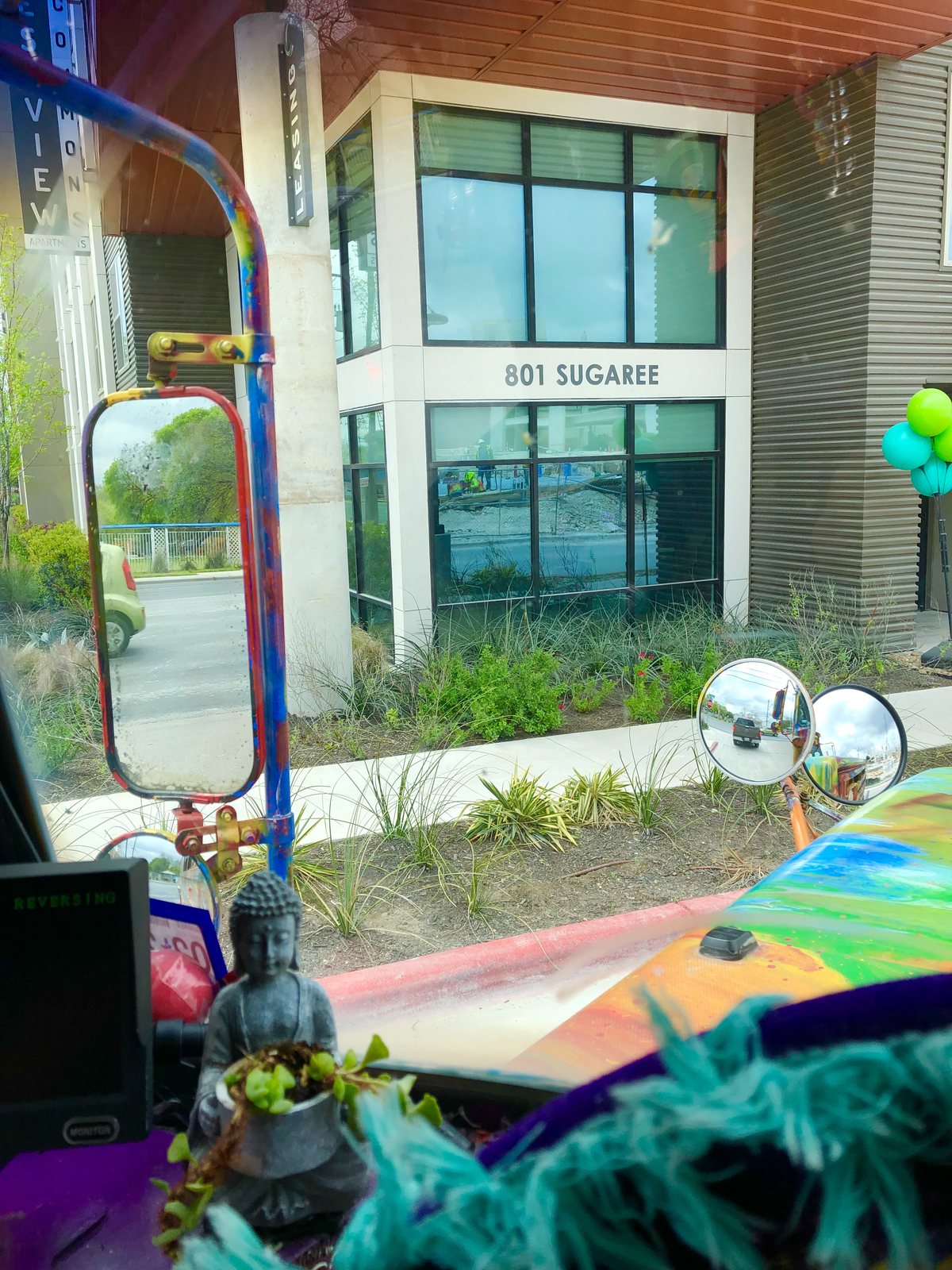 View from the driver's seat of a building marked 801 SUGAREE