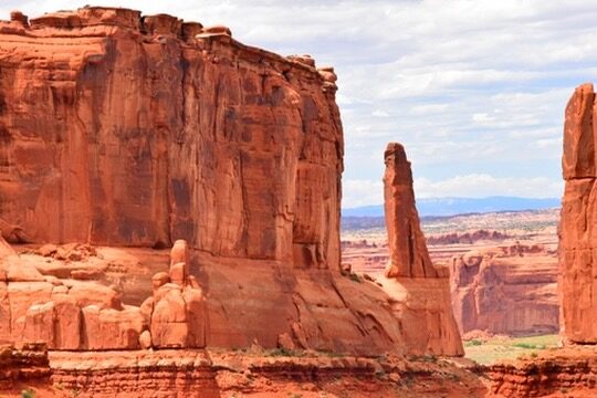 Tall red rock formations along Park Avenue in Arches National Park