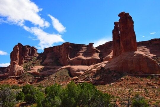 Red rock spires in Arches National Park under a blue sky