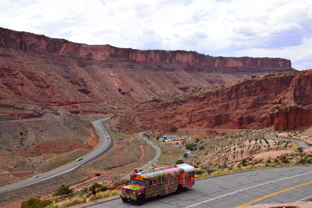 Elevated view of SUGAREE driving a winding canyon road near Moab