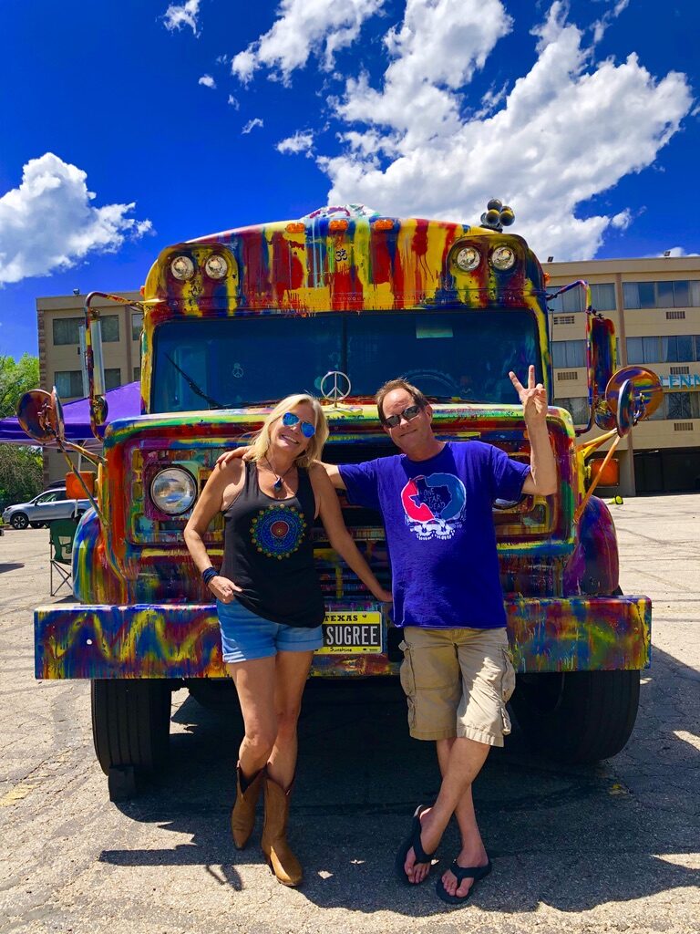 A couple posing in front of SUGAREE's peace-sign hood ornament and Texas SUGREE plate