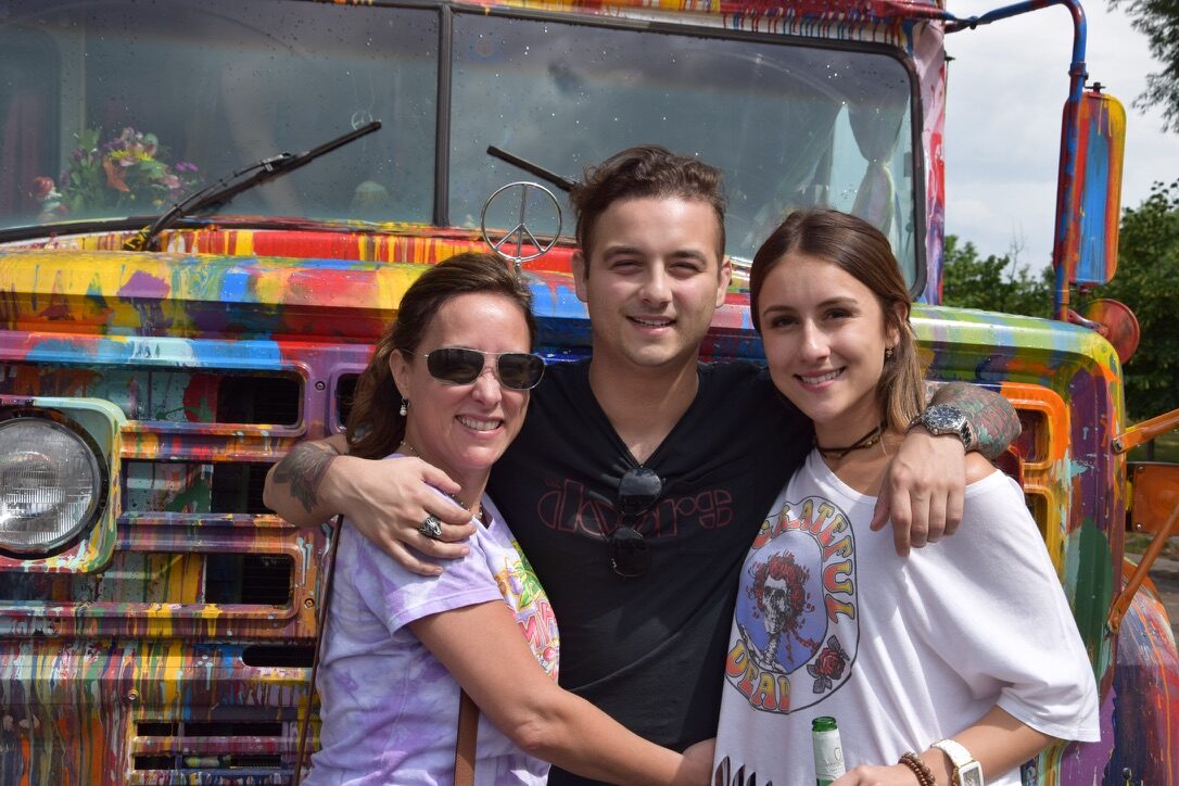 Three family members hugging in front of SUGAREE
