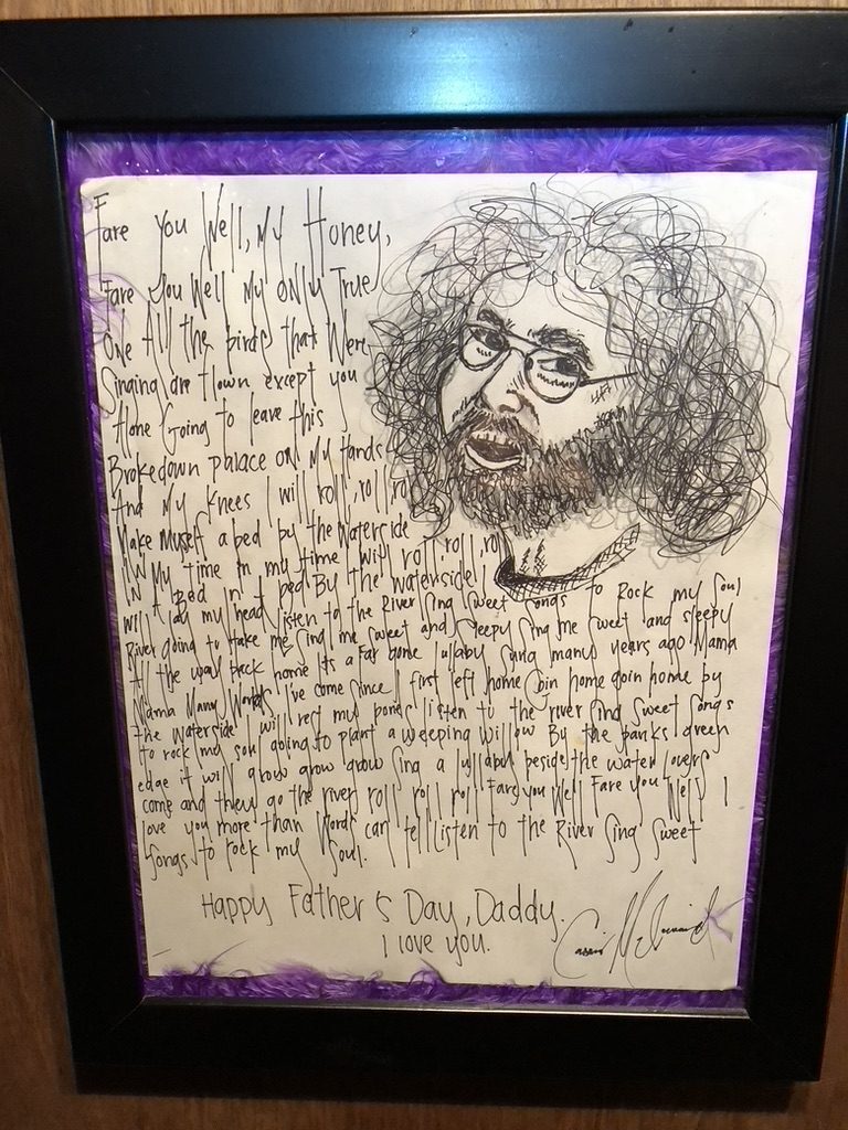 A framed, hand-lettered Father's Day keepsake with Grateful Dead lyrics and a sketch of Jerry Garcia, displayed on board