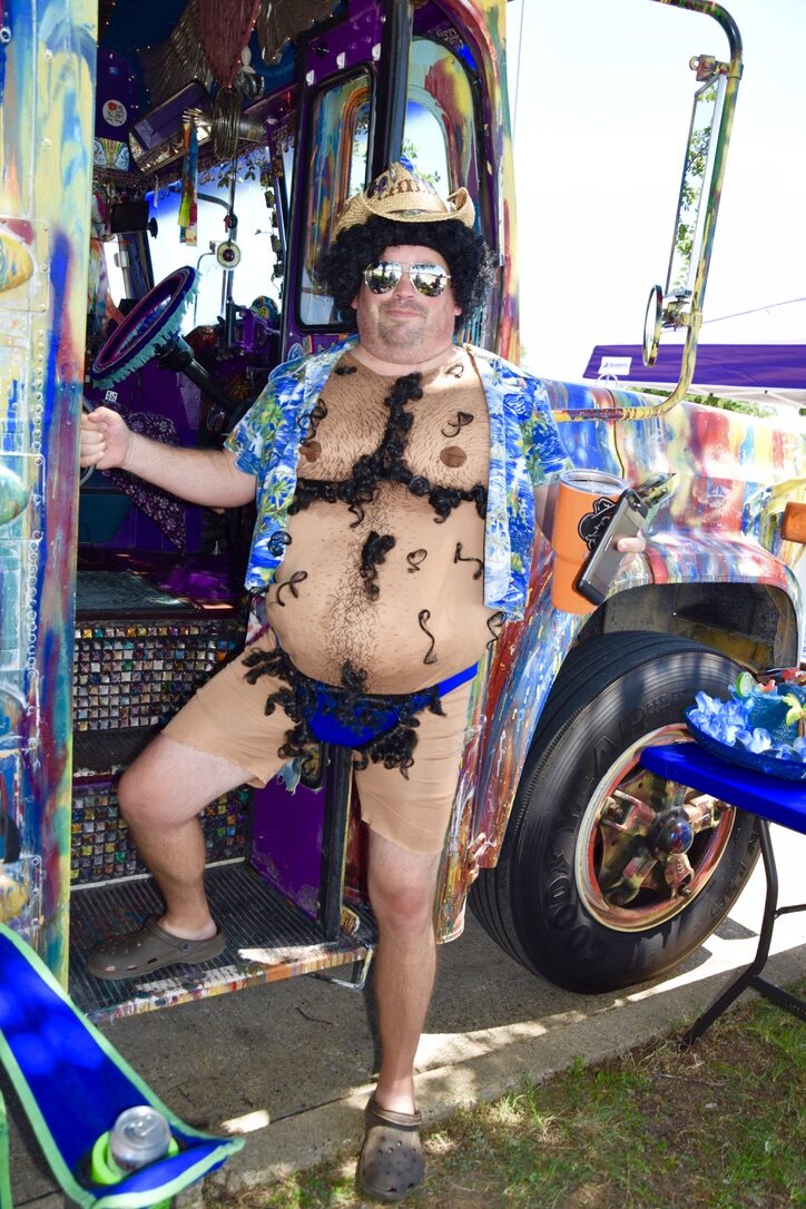 An overly-hairy guy at a Jimmy Buffett show, standing at SUGAREE's open door