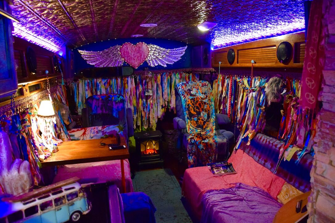 SUGAREE's interior lounge lit in purple, with a winged heart decoration on the wall