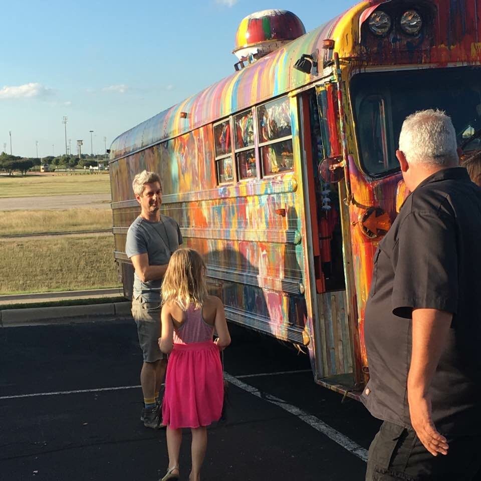 Mike Gordon of Phish and his daughter checking out SUGAREE in a parking lot