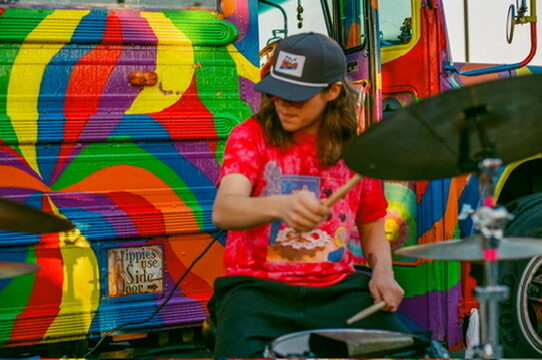 A woman flashing a peace sign in front of SUGAREE