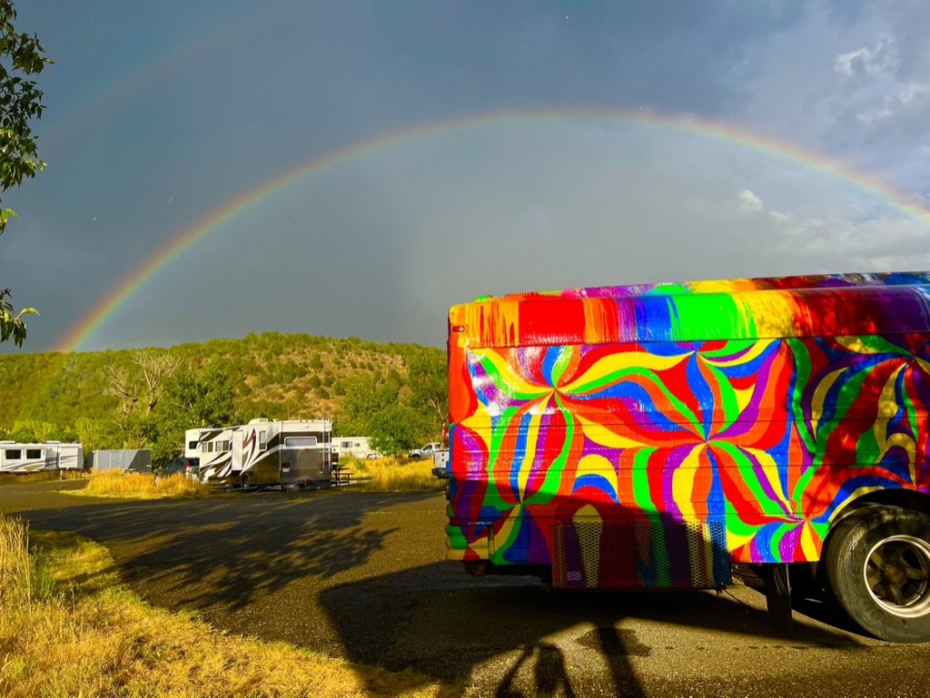 A rainbow arcing over the RV park behind SUGAREE's painted rear end