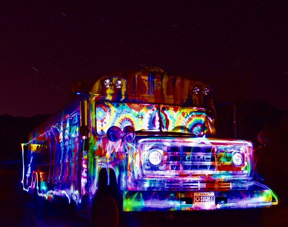 SUGAREE lit up in rainbow light painting under star trails, viewed from the front