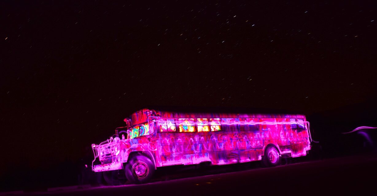 SUGAREE outlined in swirling pink light painting against a starry night sky