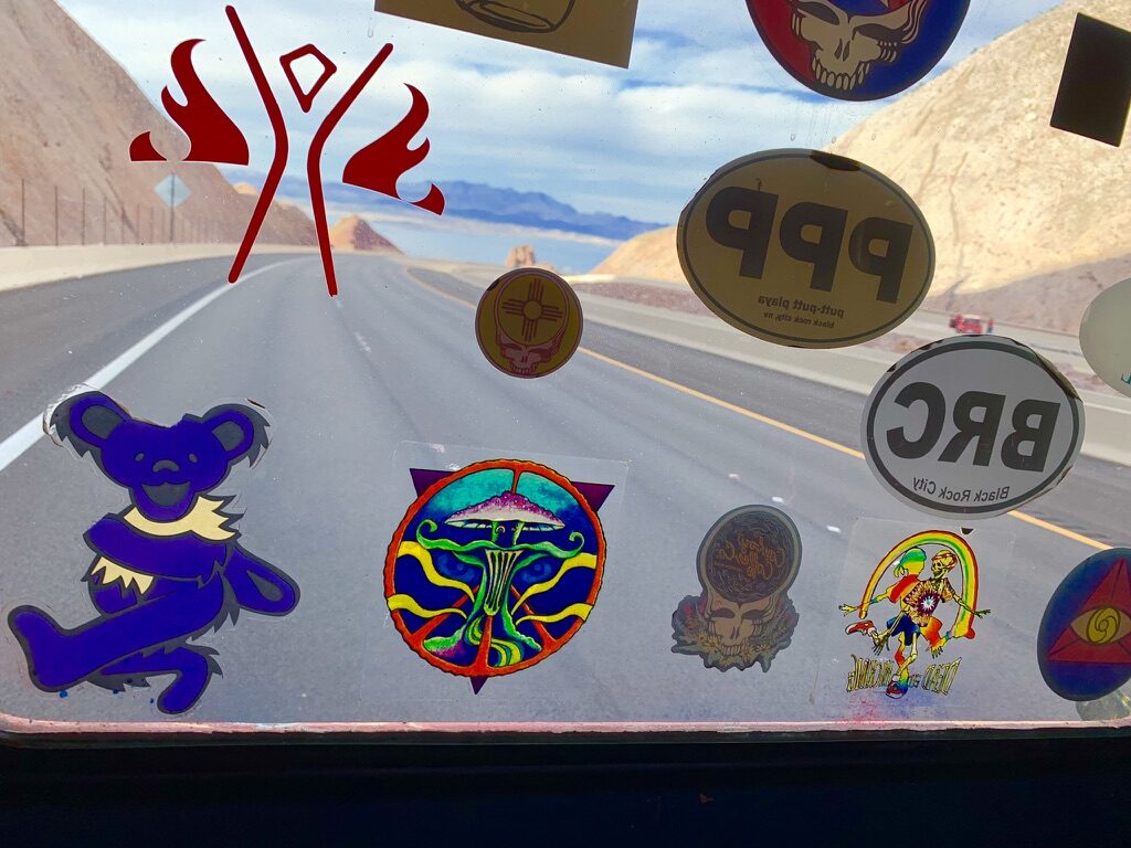 View through SUGAREE's sticker-covered windshield while driving through the desert