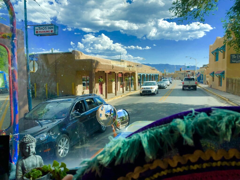 View through SUGAREE's windshield of downtown Taos, New Mexico, with the Taos Inn parking sign