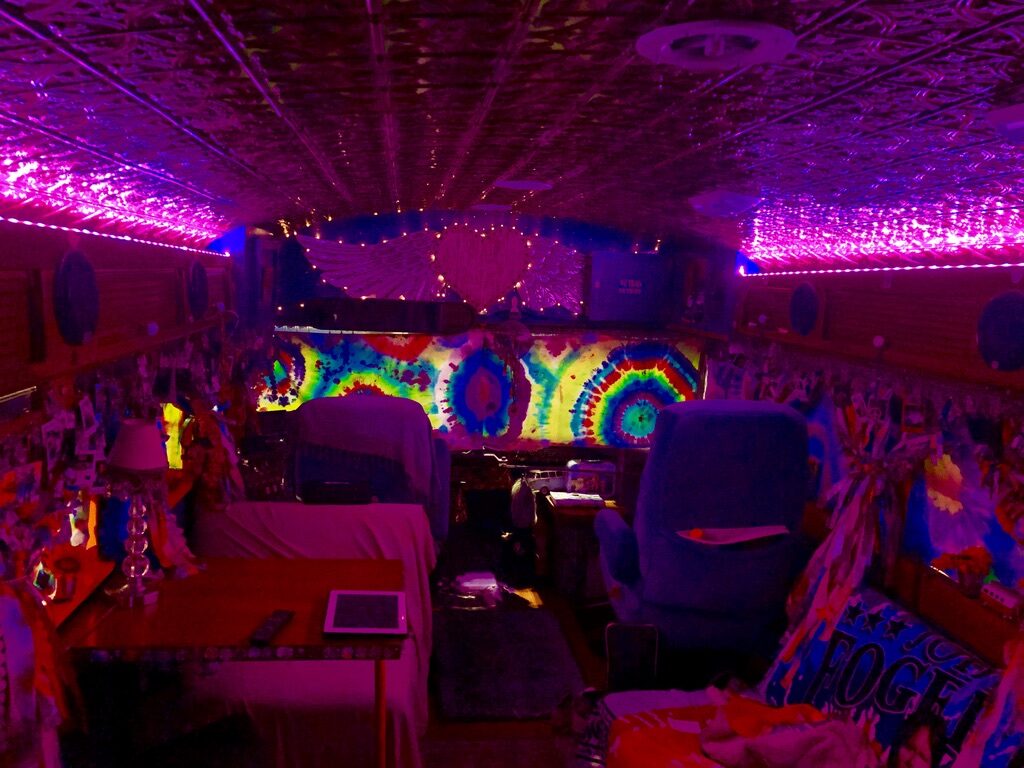 SUGAREE's tie-dye painted interior ceiling lit up in pink and purple