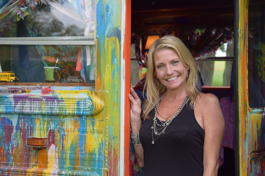 A woman standing in SUGAREE's side doorway