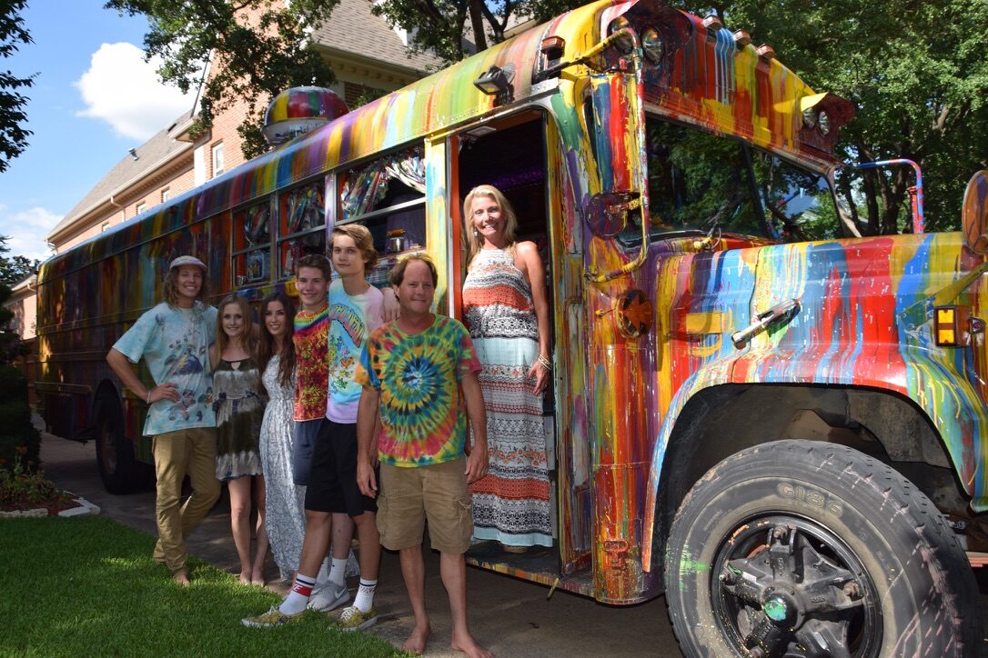 Seven family members and friends posing at SUGAREE's door in a driveway